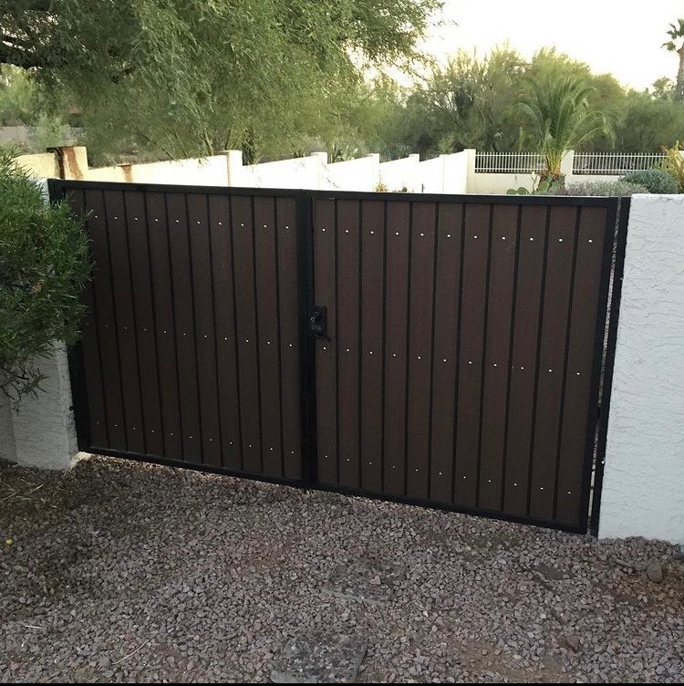 Dual swing RV gate with composite slats and a steel frame